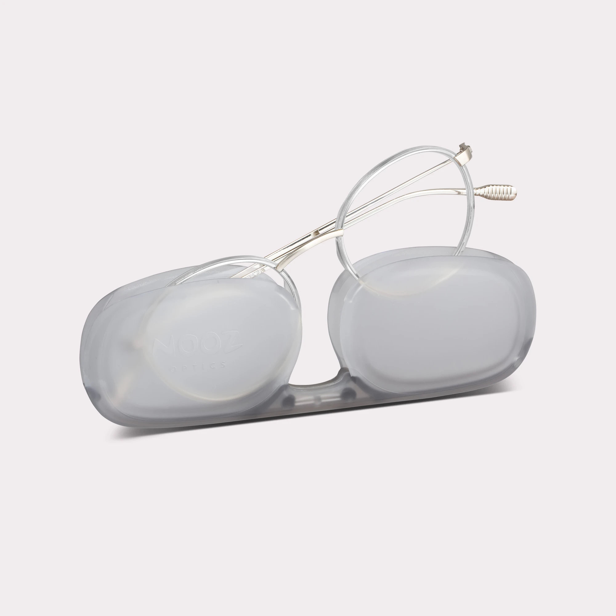 A pair of Ela Crystal Reading glasses coming out of its case