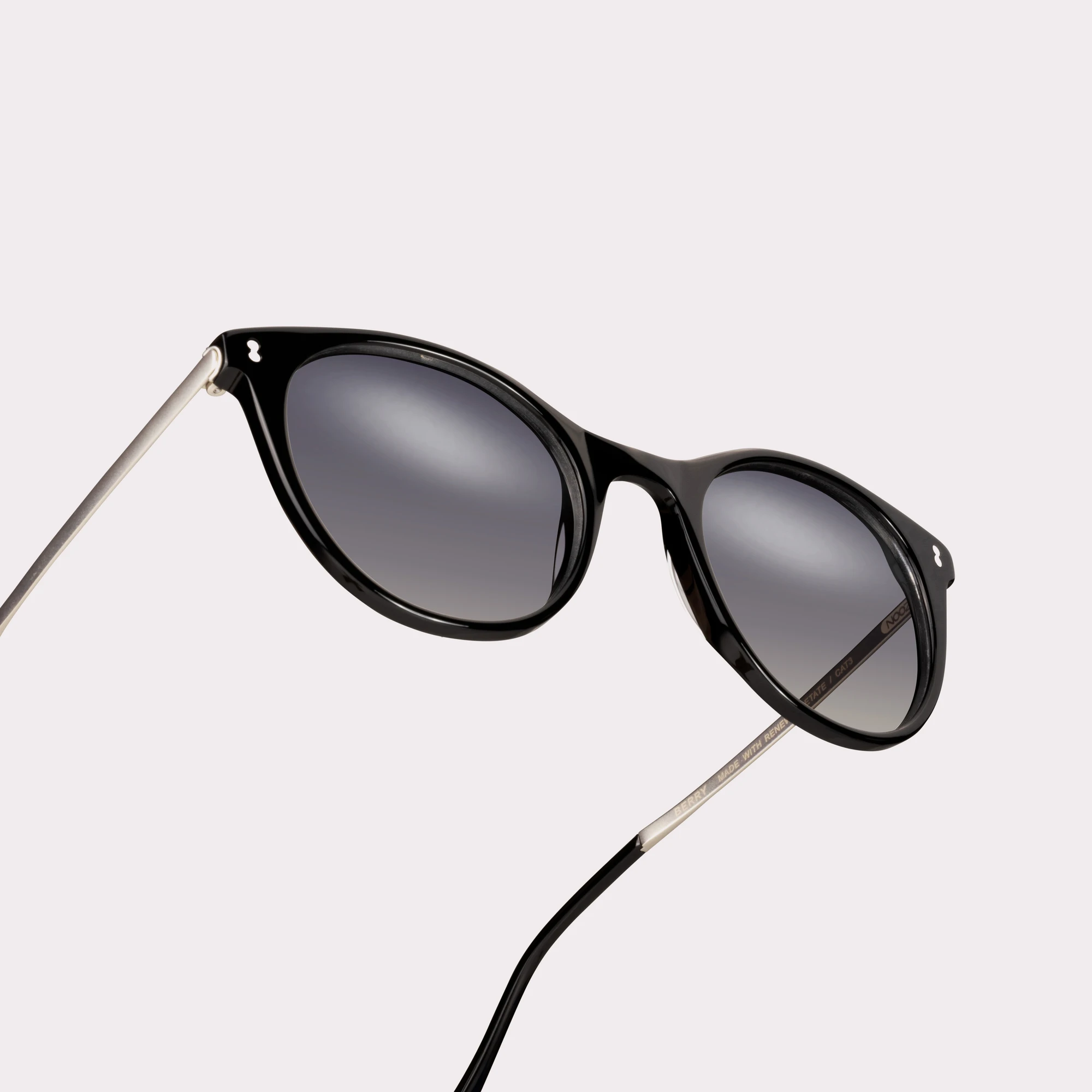 A pair of Berry Black Sunglasses in a macro view