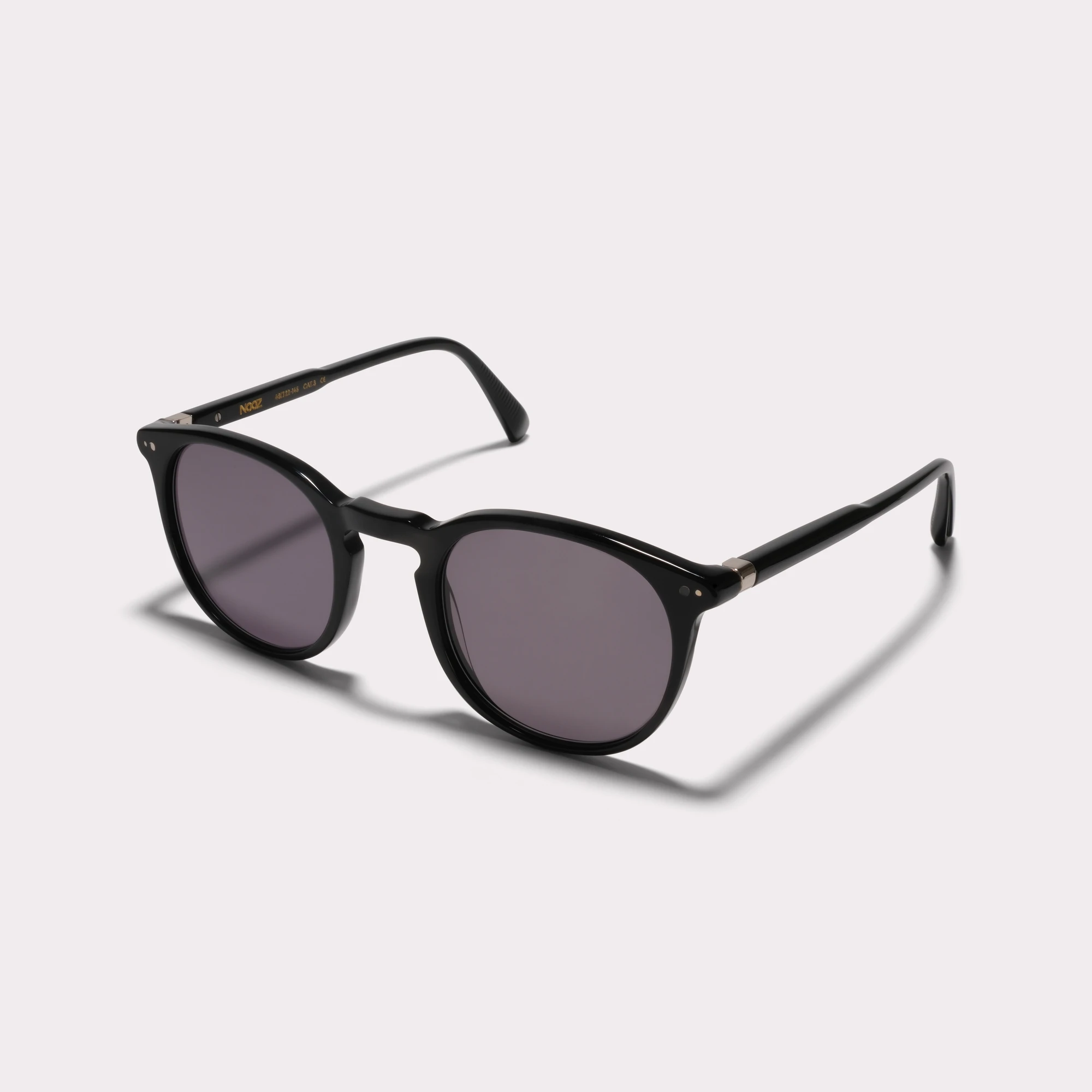 A pair of Basil Black Sunglasses  seen from the side