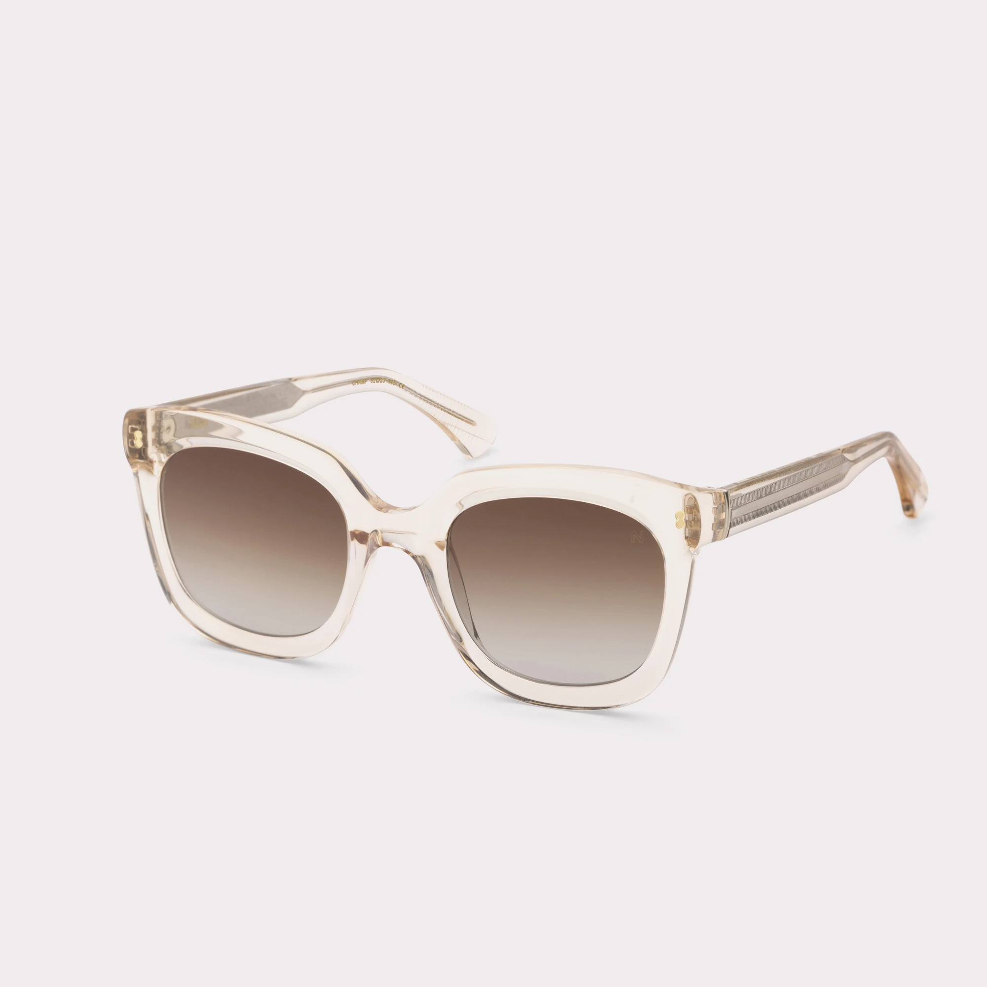 A pair of Sky Champagne Sunglasses  seen from the side