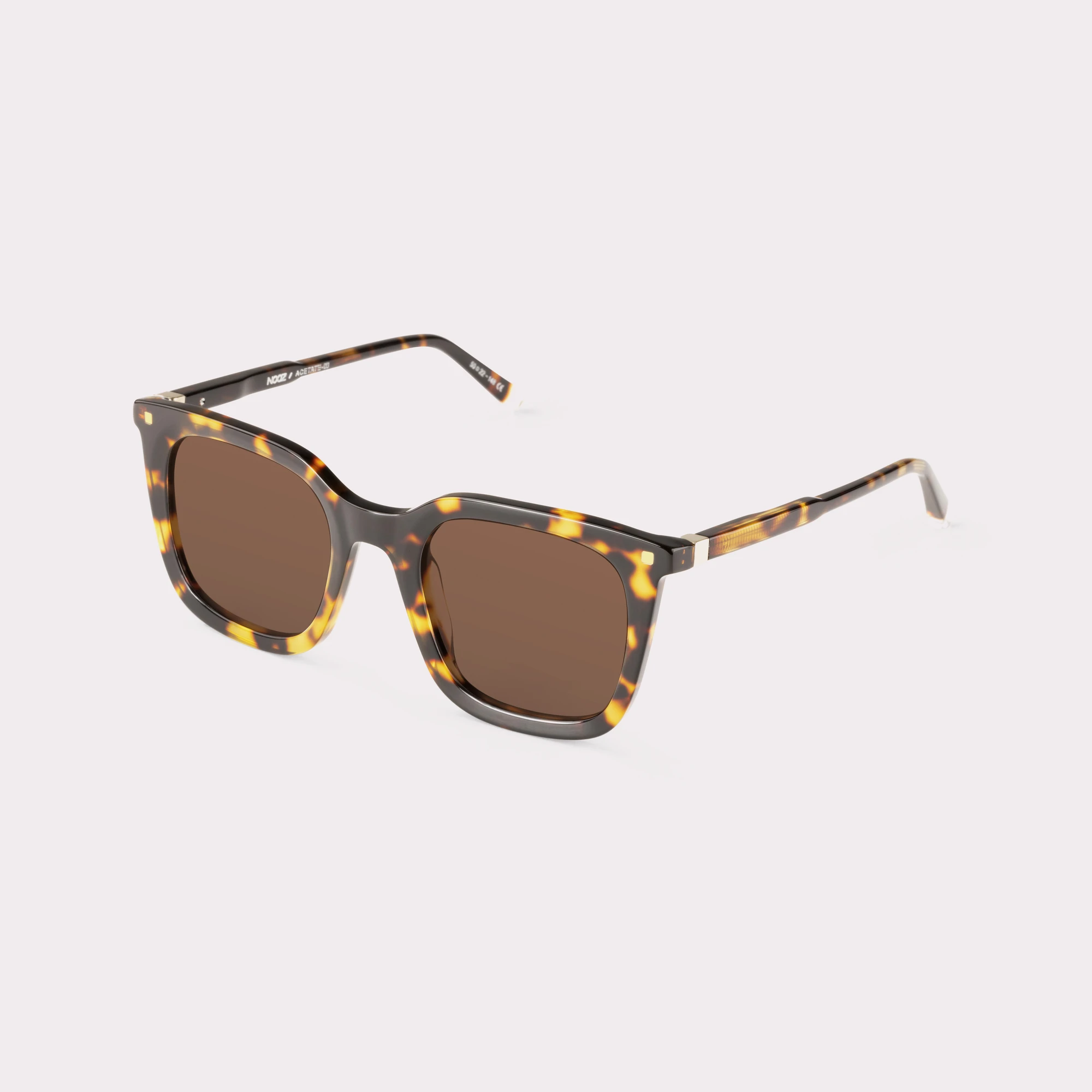 A pair of Candid Dark tortoise Sunglasses  seen from the side