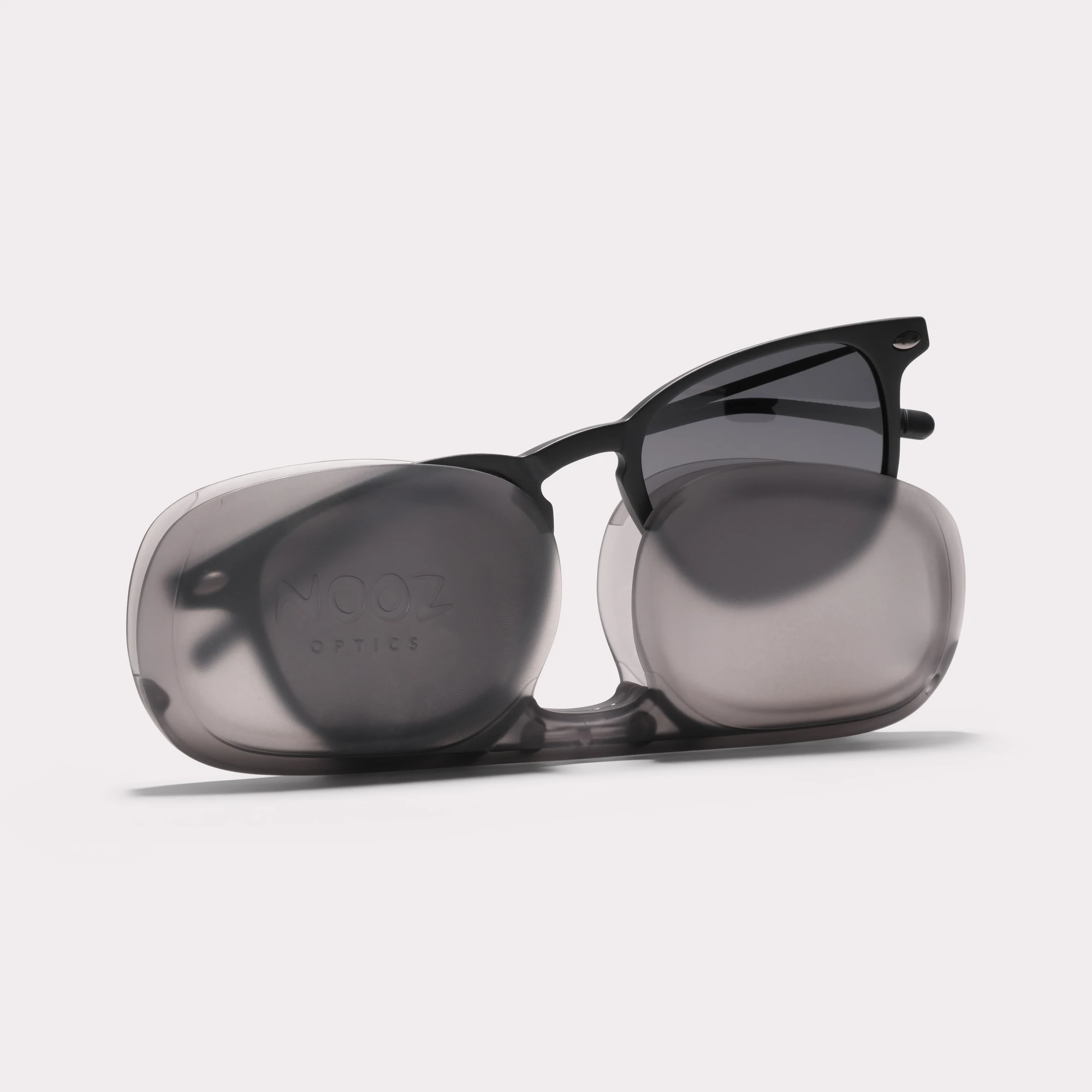 A pair of Doni Black Sunglasses coming out of its case