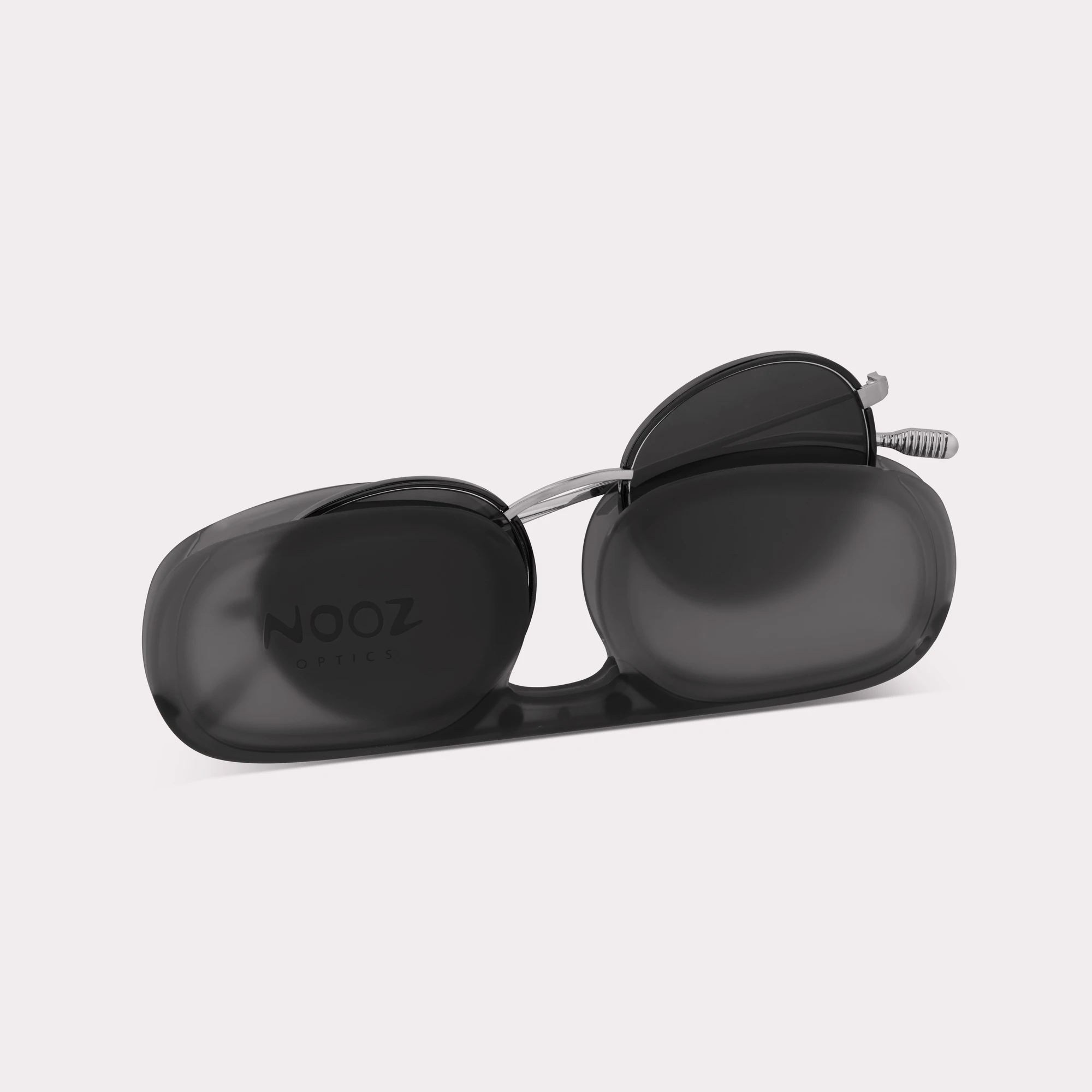A pair of Ela Black Sunglasses coming out of its case