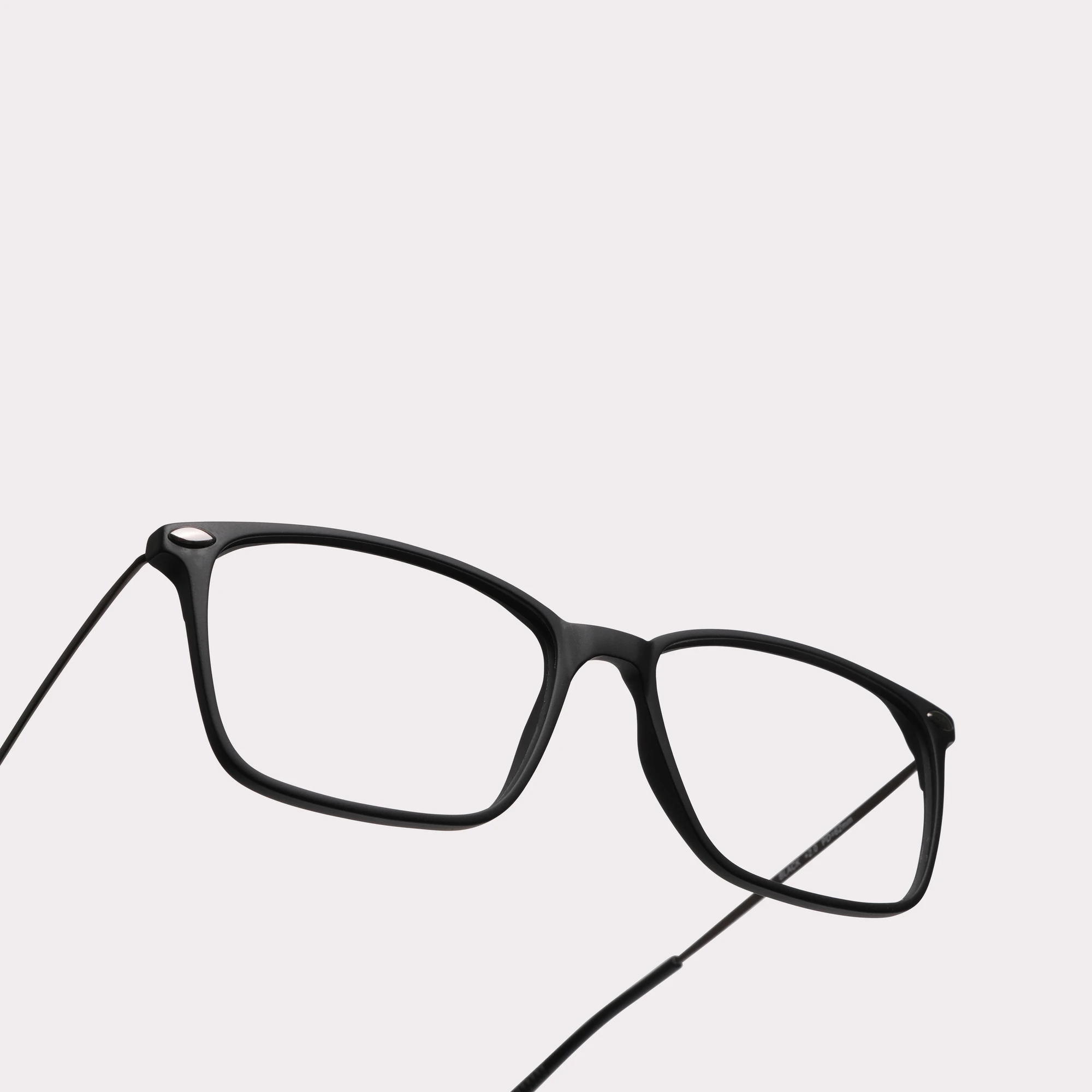 A pair of Bao Black Reading glasses in a macro view