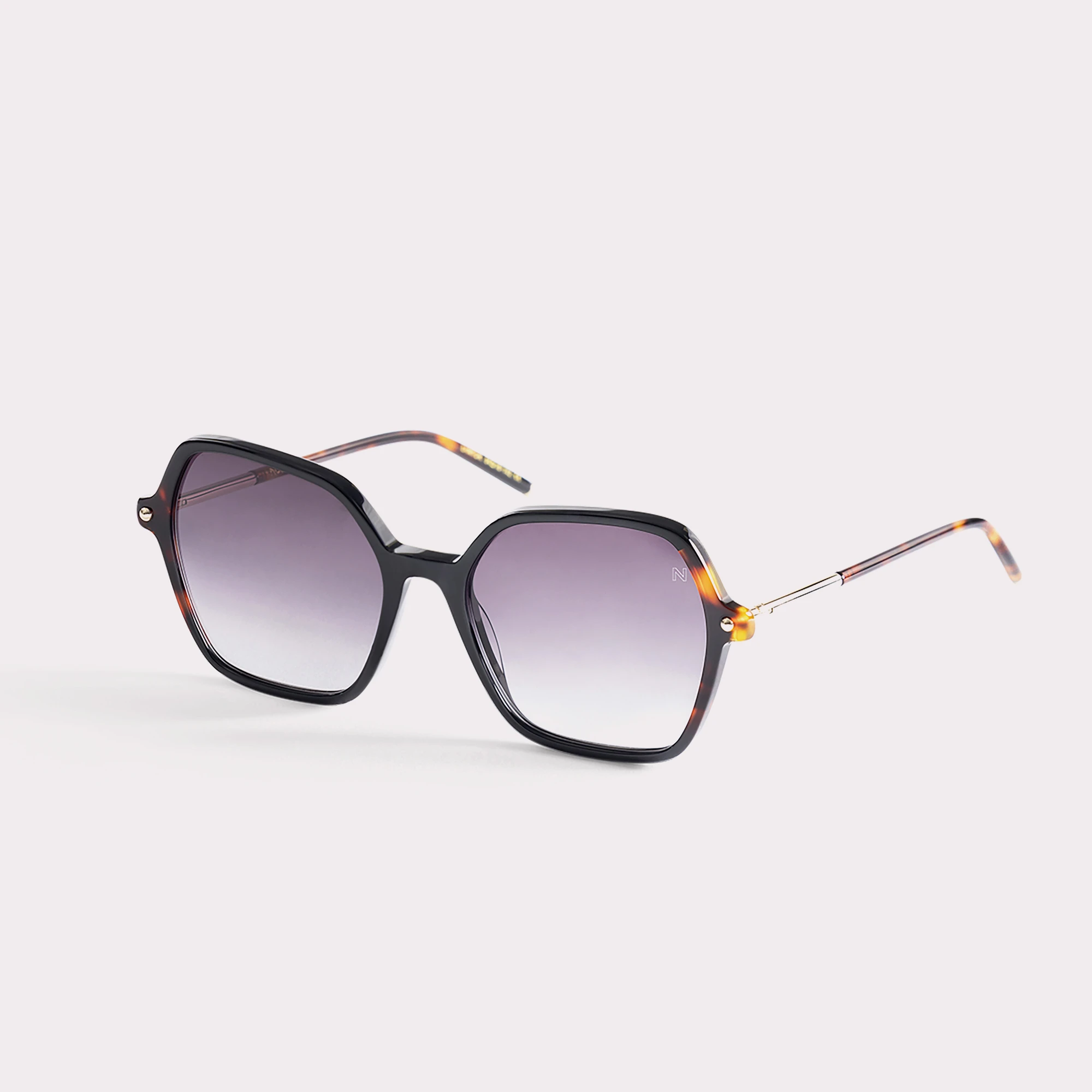 A pair of Peach Tortoise Sunglasses  seen from the side
