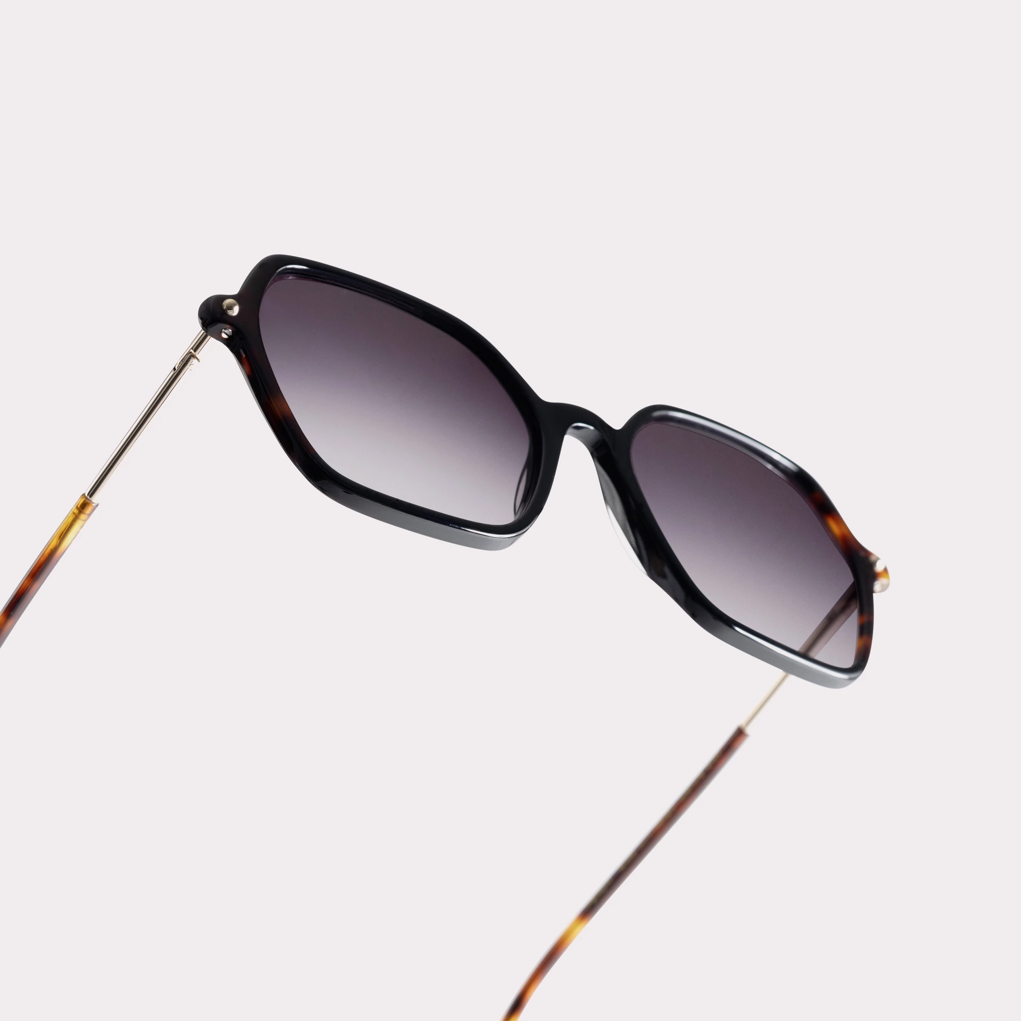 A pair of Peach Tortoise Sunglasses in a macro view