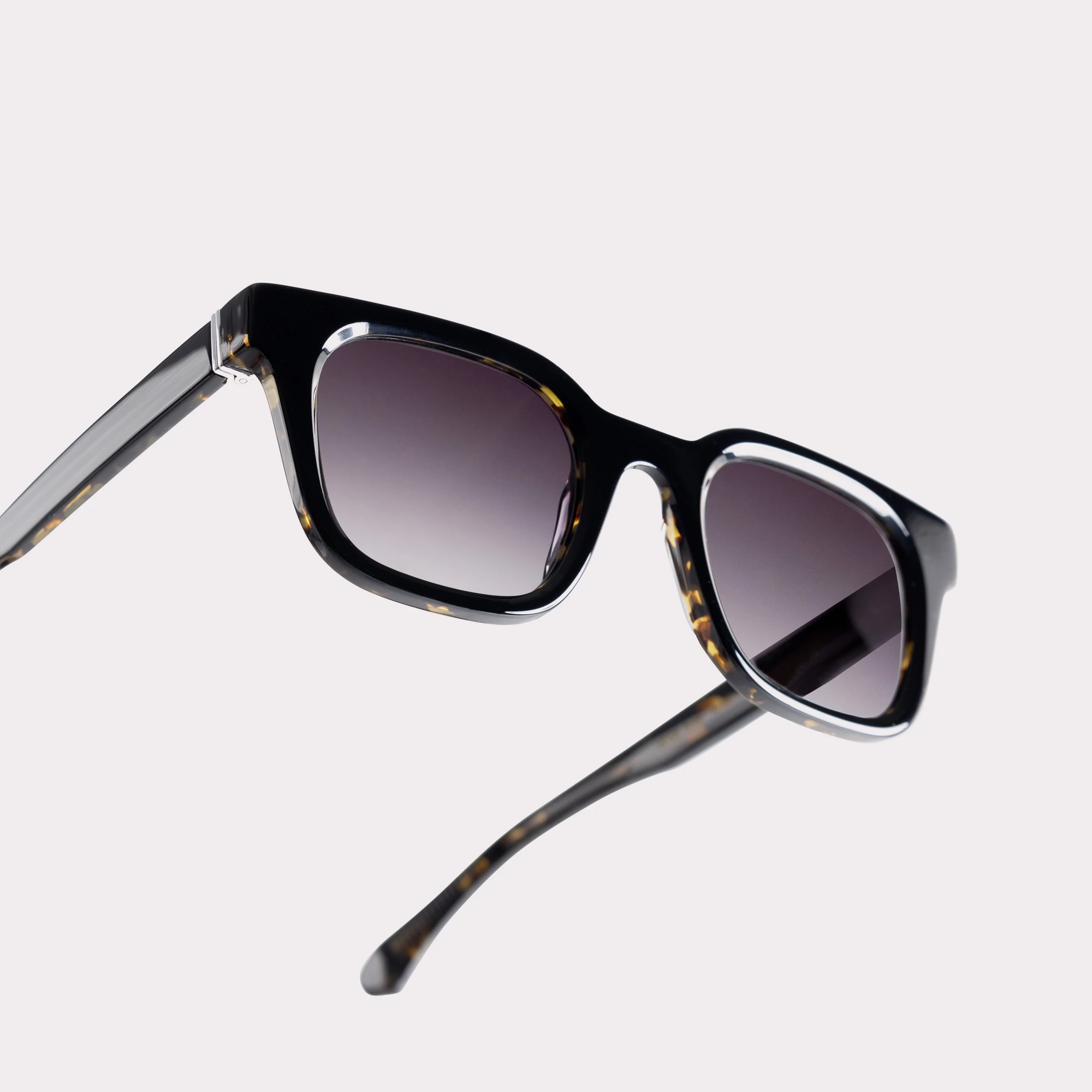 A pair of Vega Black Sunglasses in a macro view