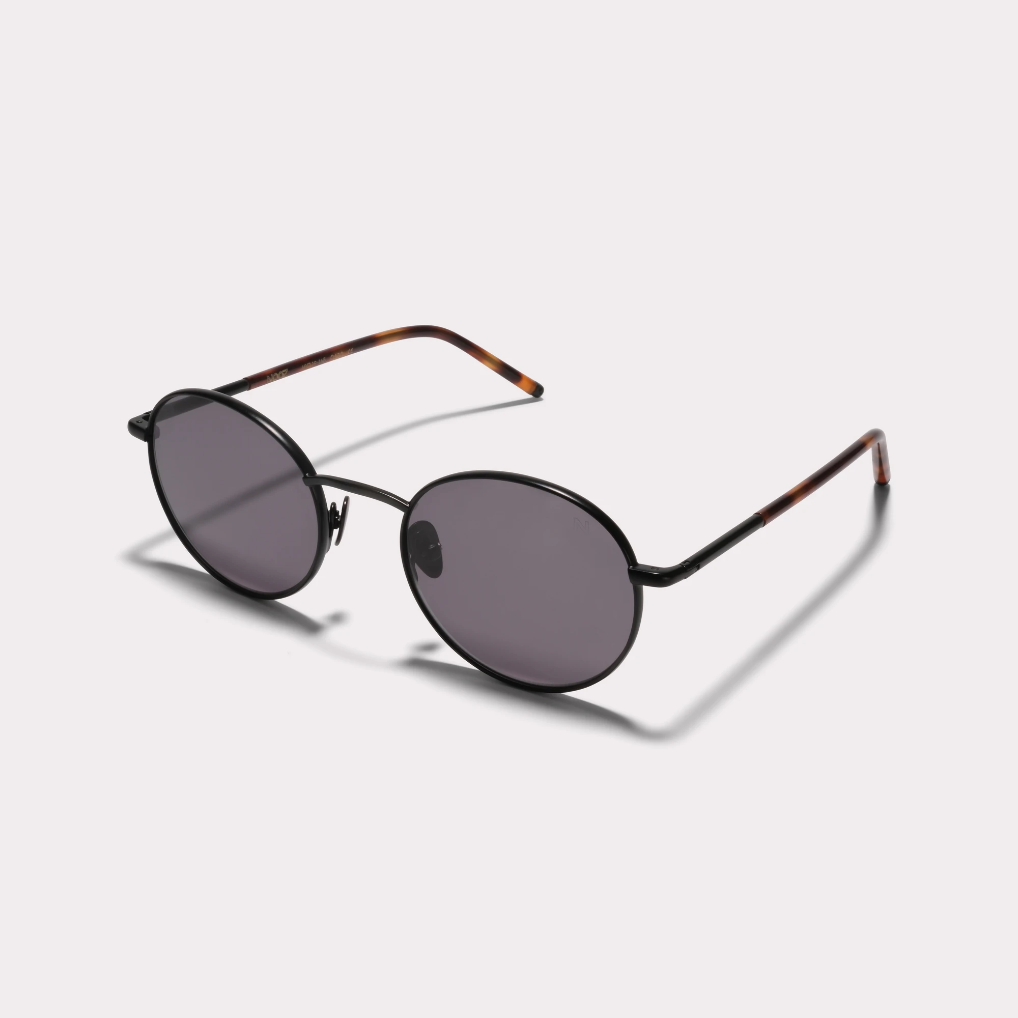 A pair of Ted Black Sunglasses  seen from the side
