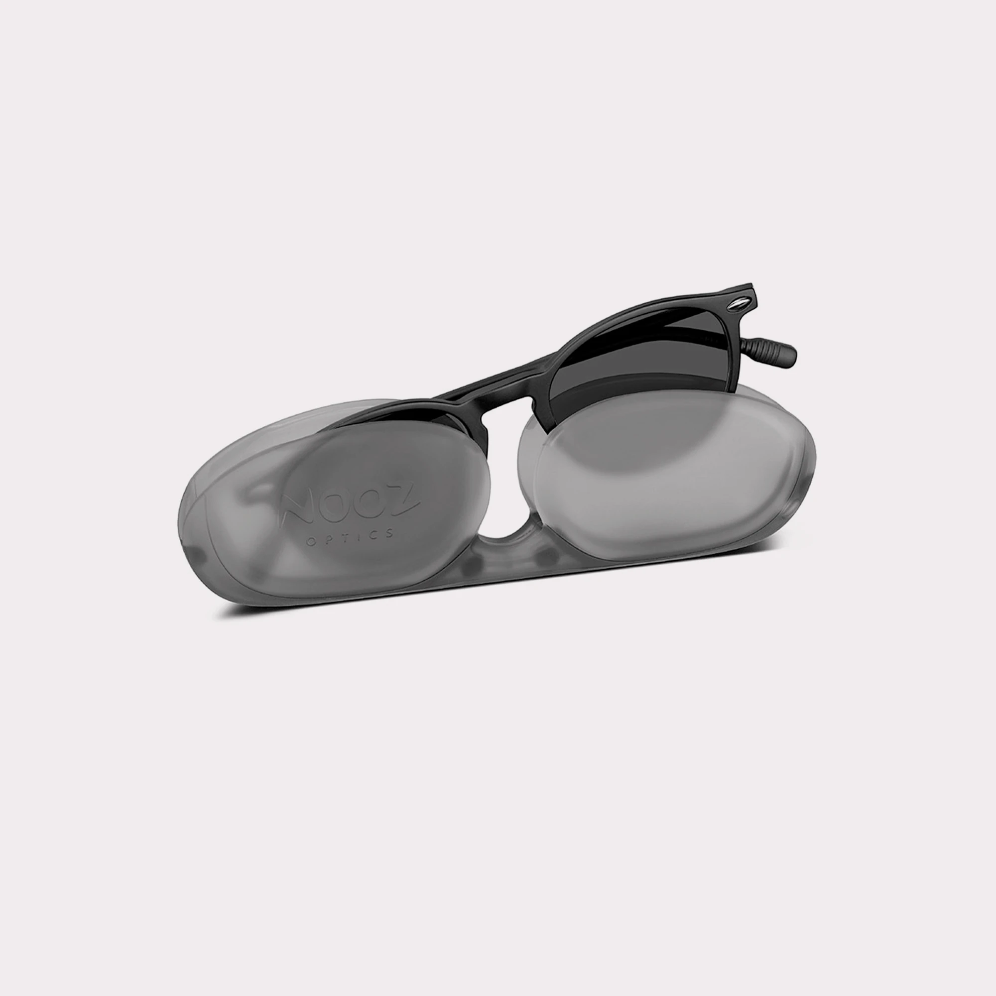A pair of Cruzy Black Sunglasses for children coming out of its case