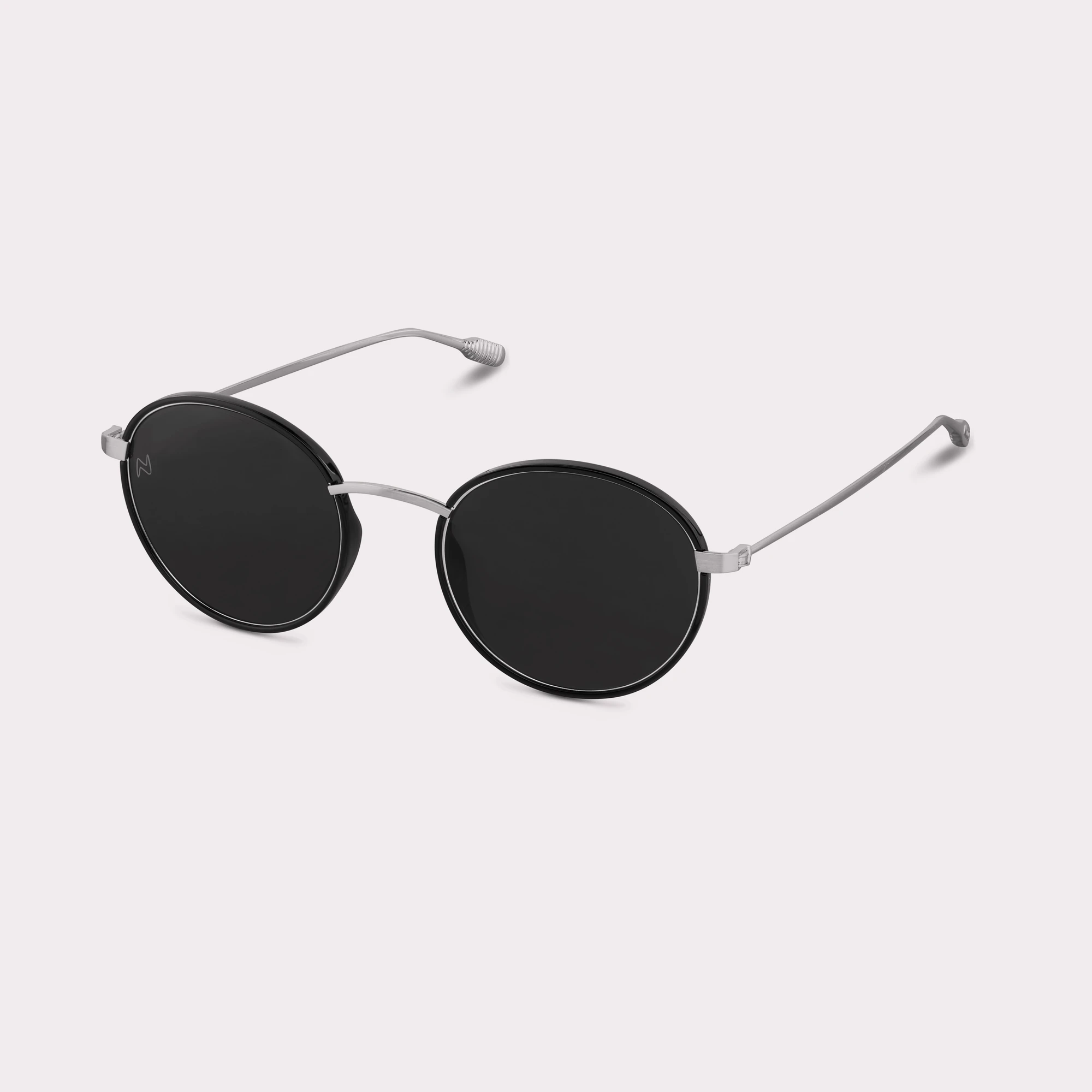 A pair of Ela Black Sunglasses  seen from the side