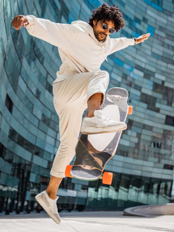 NOOZ OPTICS sunglasses worn by a man who is skateboarding