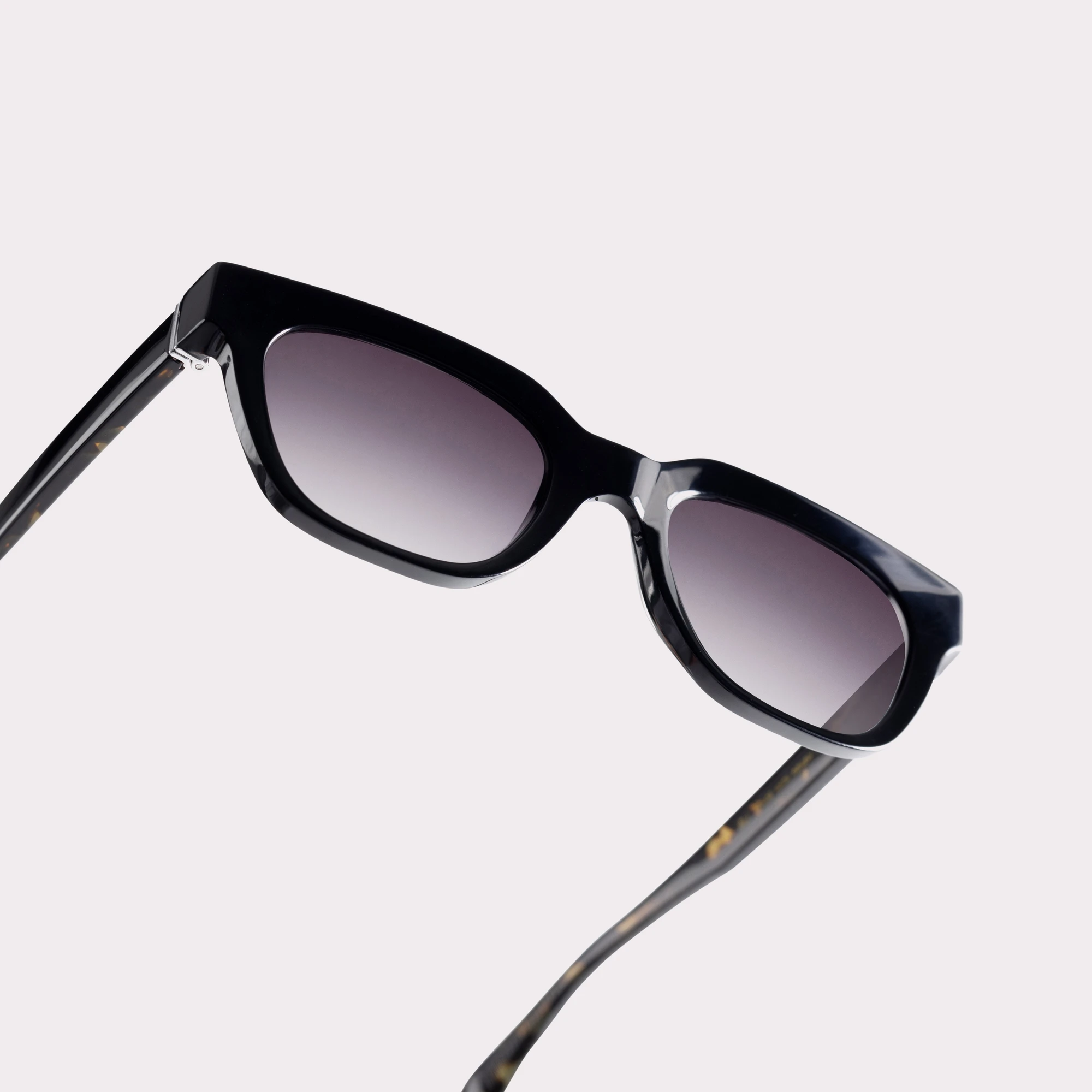 A pair of Eli Black Sunglasses in a macro view