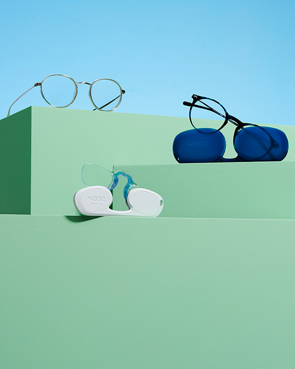 a pair of glasses sitting on top of a shelf.