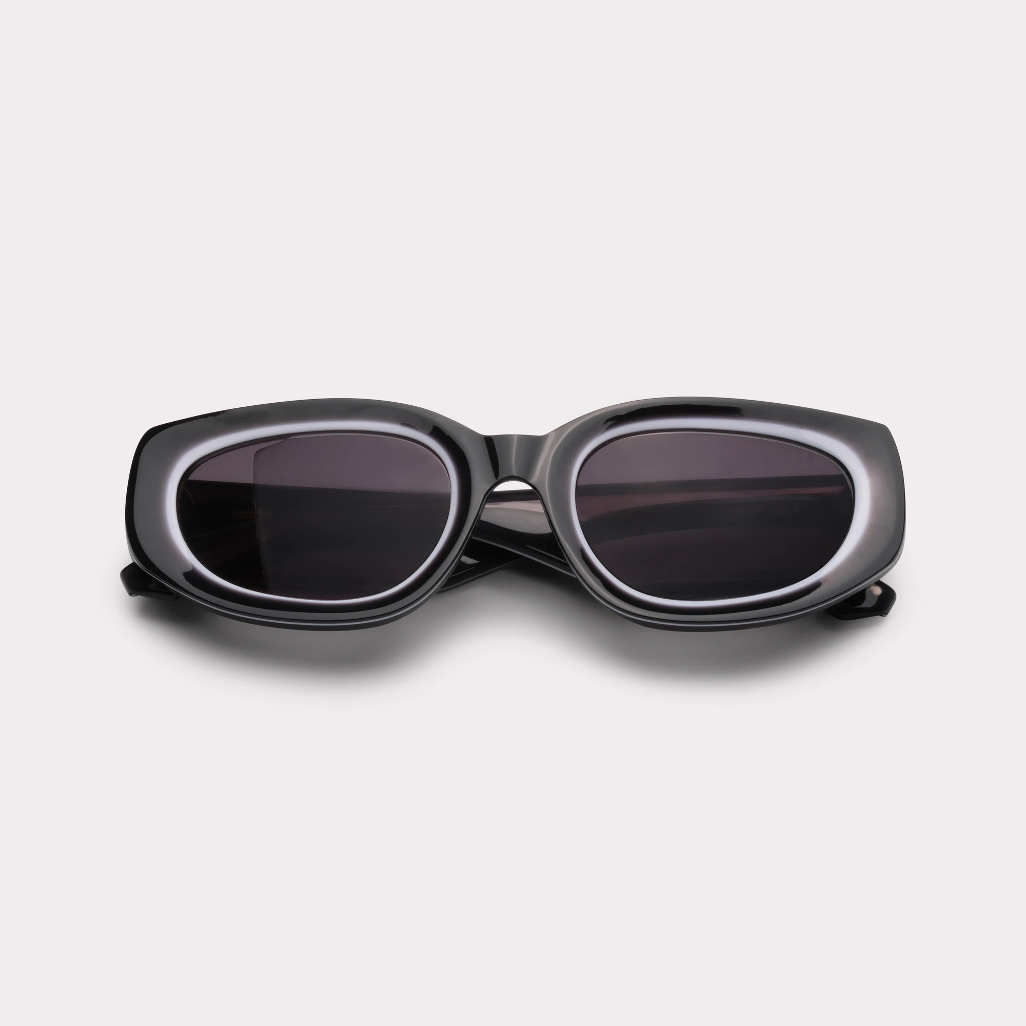 A pair of Lola Black Sunglasses folded