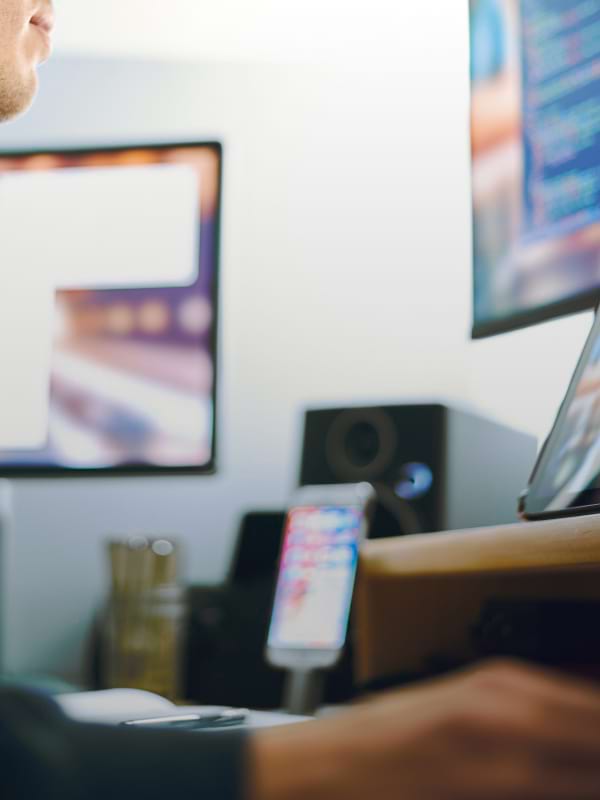 Woman wearing glasses typing on the keyboard of his laptop