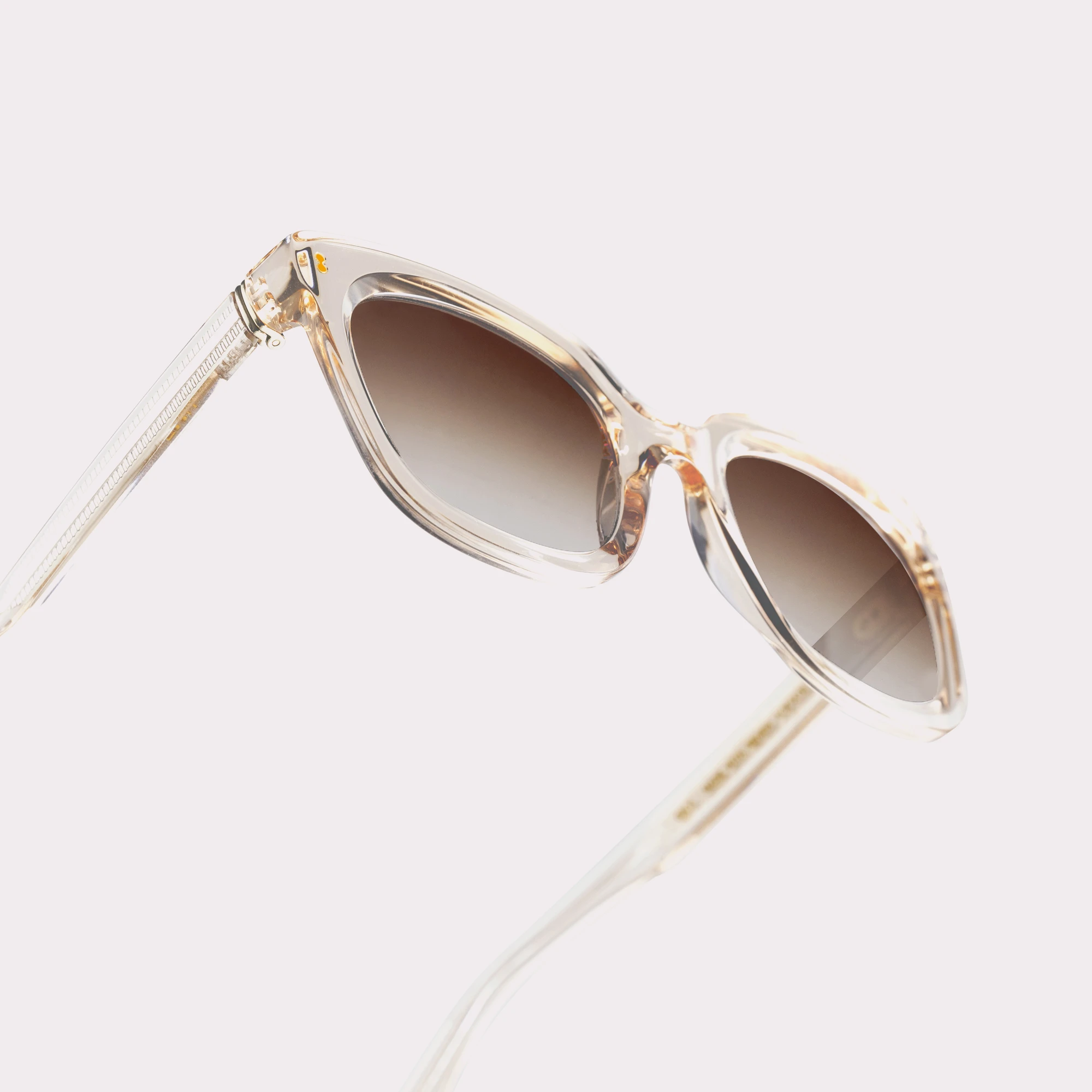 A pair of Sky Champagne Sunglasses in a macro view