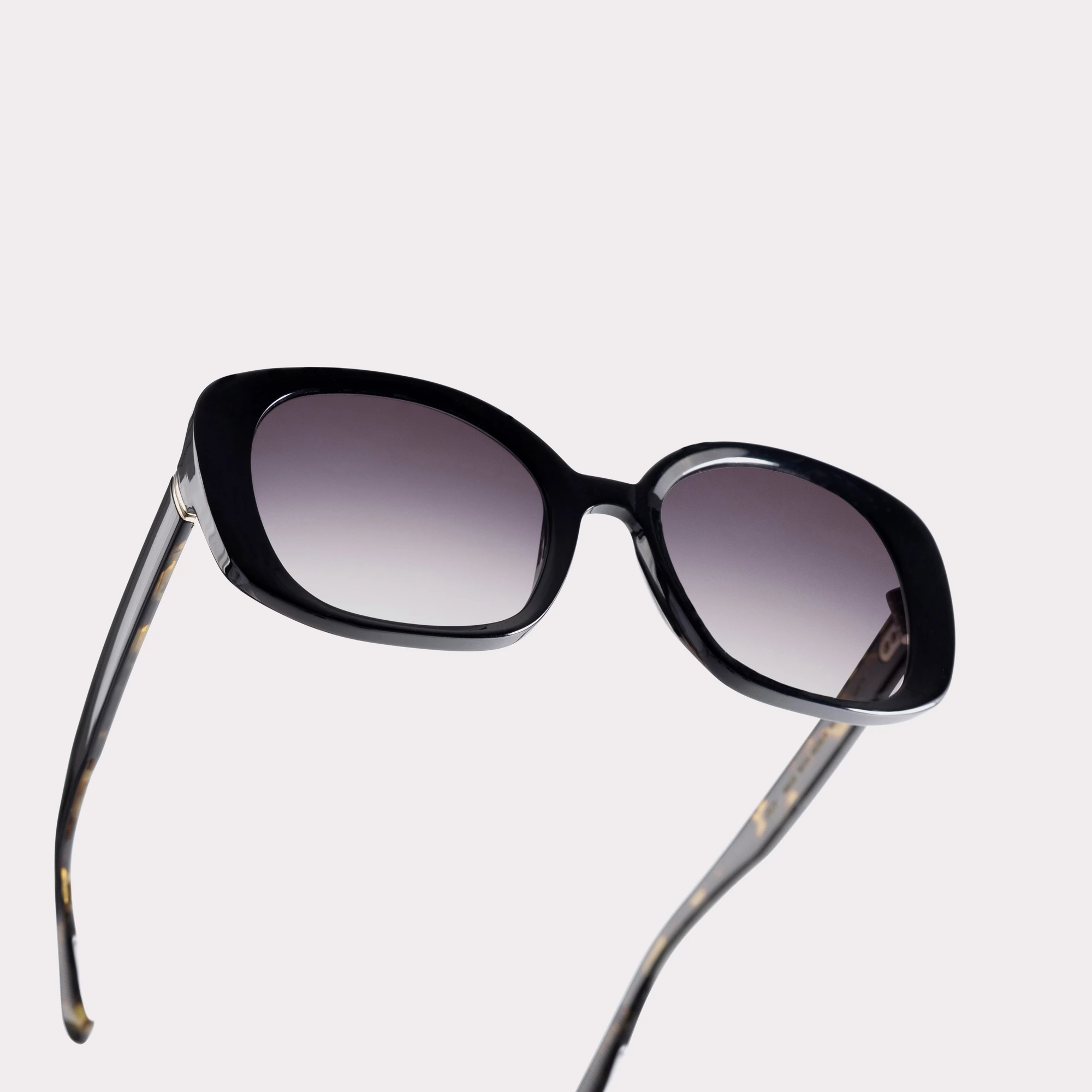 A pair of Joy Black Sunglasses in a macro view