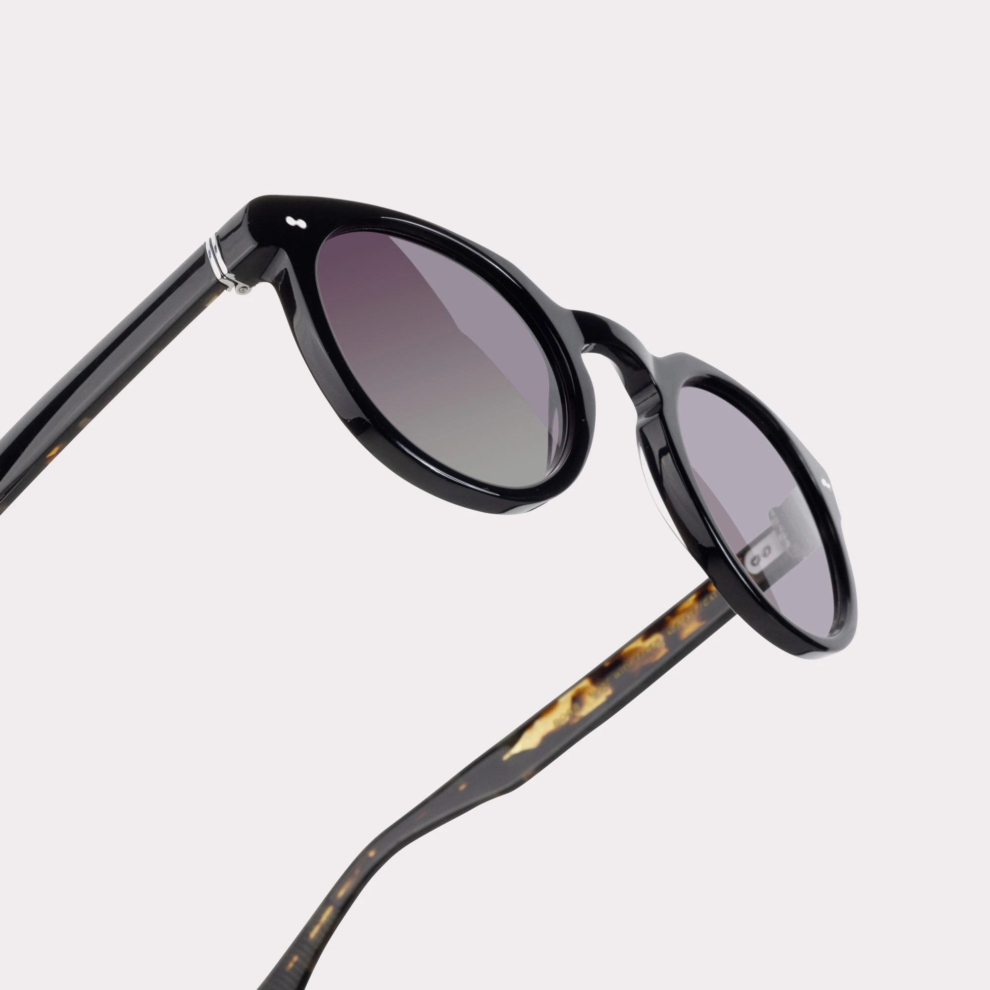 A pair of Robb Black Sunglasses in a macro view