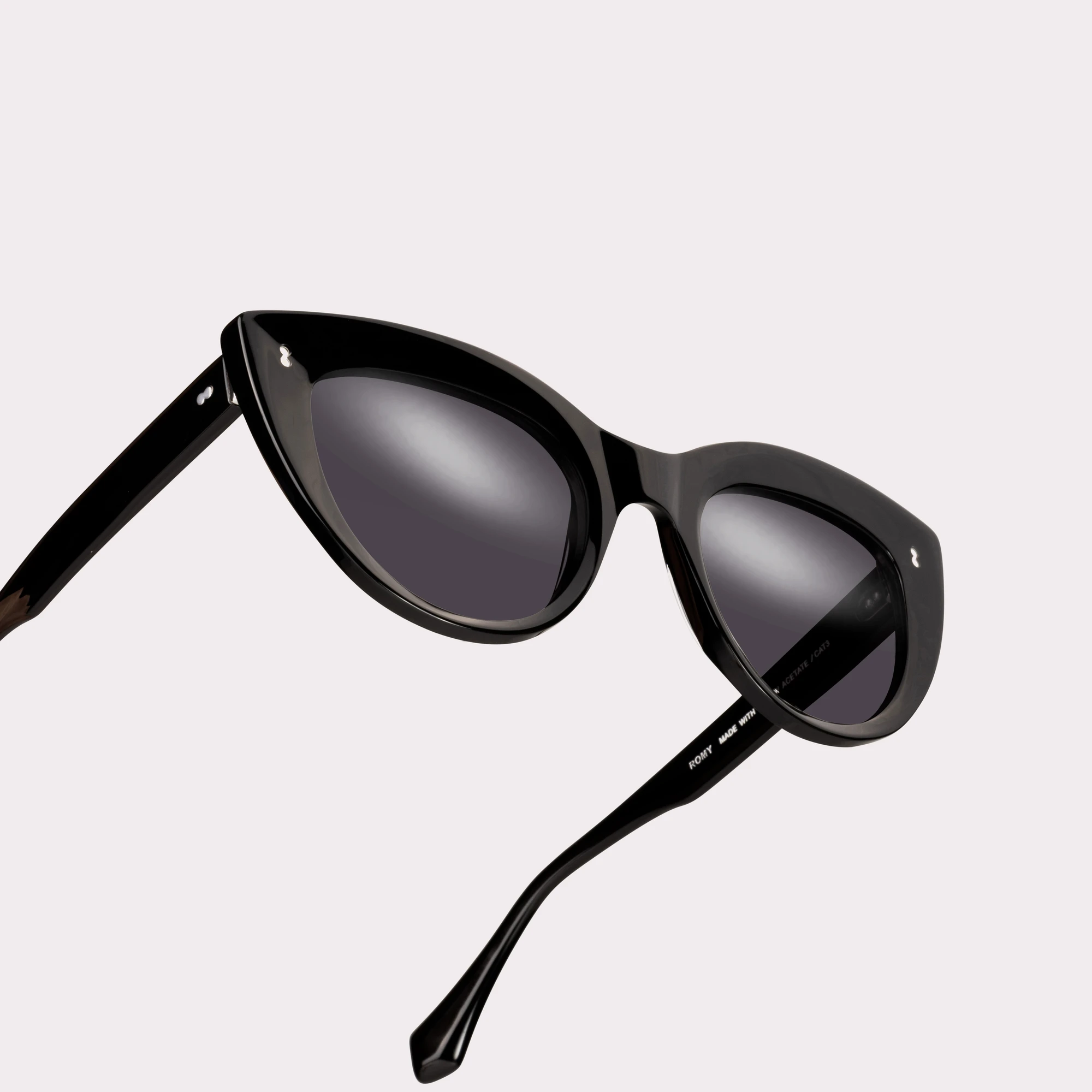 A pair of Romy Black Sunglasses in a macro view