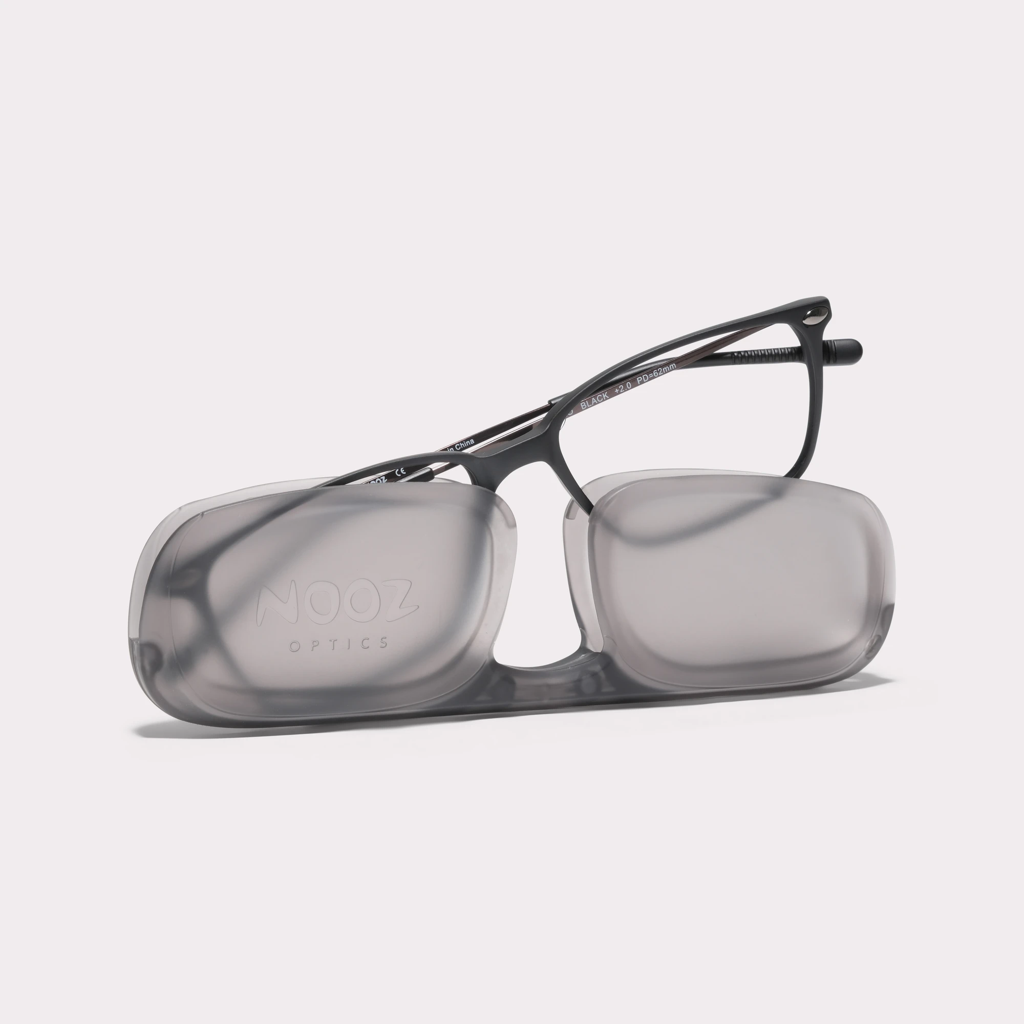 A pair of Bao Black Reading glasses coming out of its case