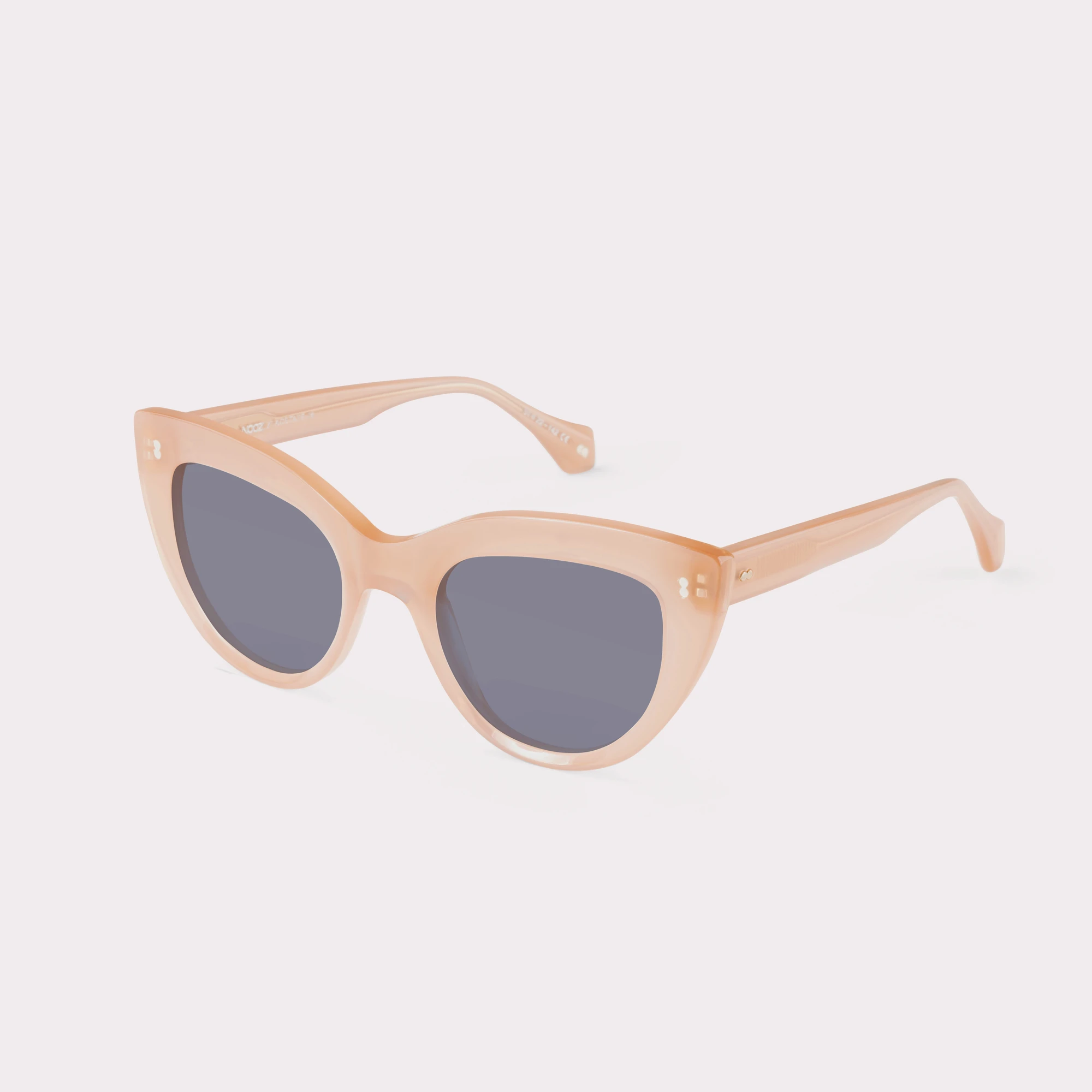 A pair of Romy Milky Pink Sunglasses  seen from the side
