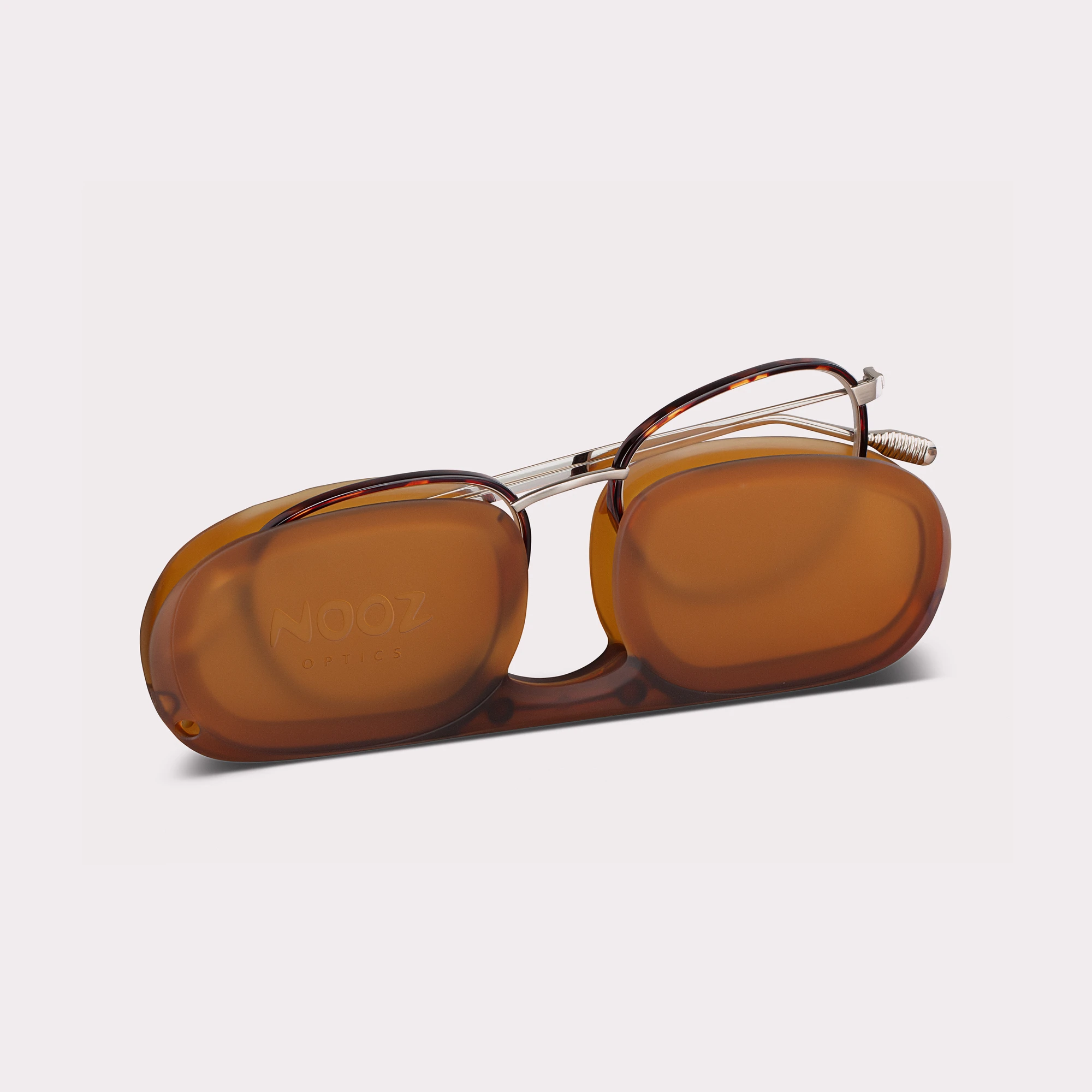 A pair of Gali Tortoise Reading glasses coming out of its case