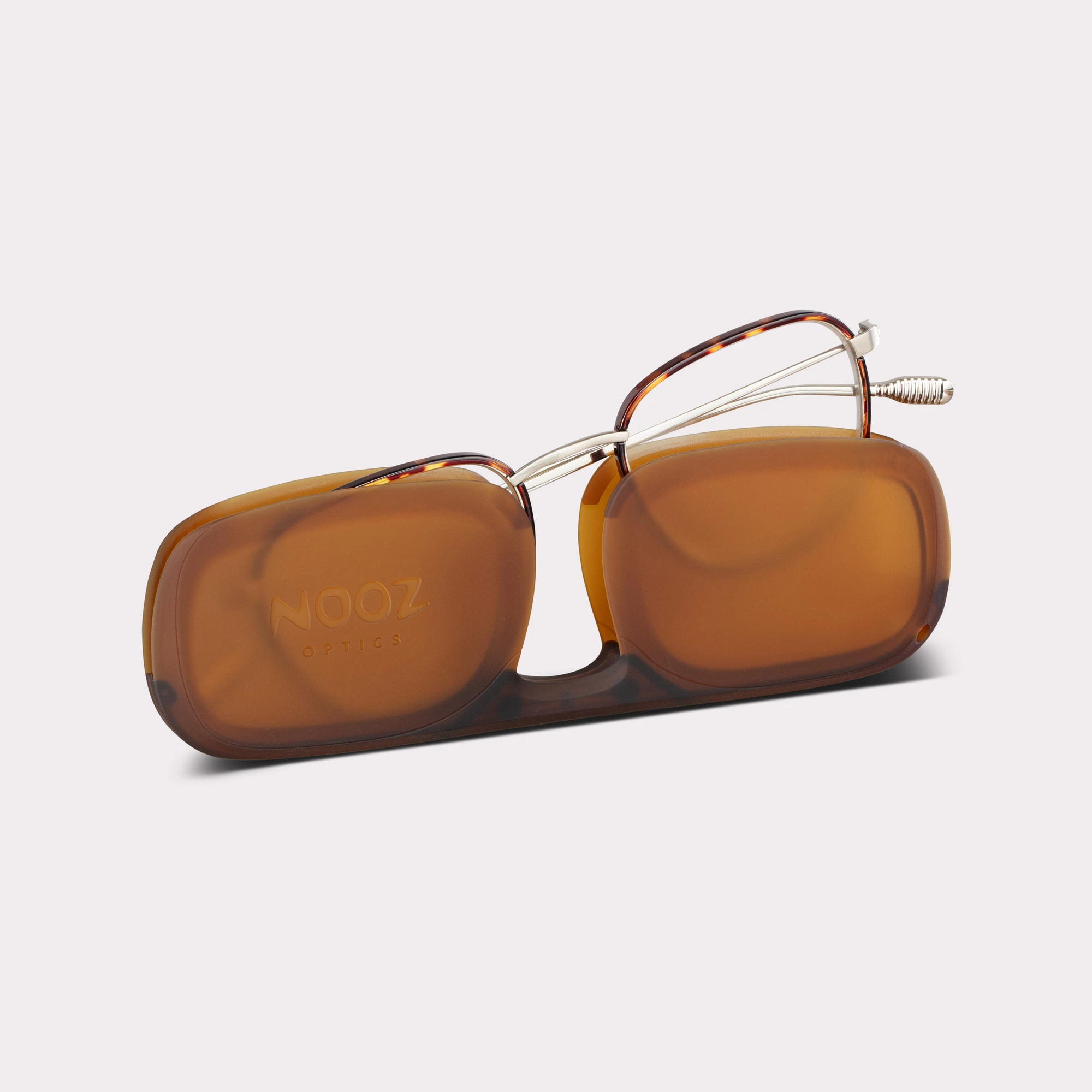 A pair of Hiro Tortoise Reading glasses coming out of its case