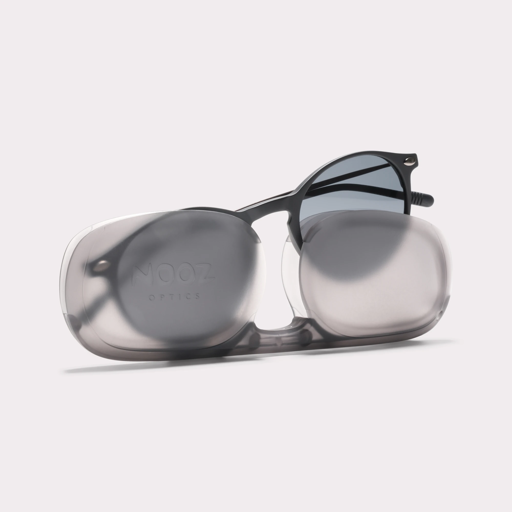 A pair of Cruz Black Sunglasses coming out of its case