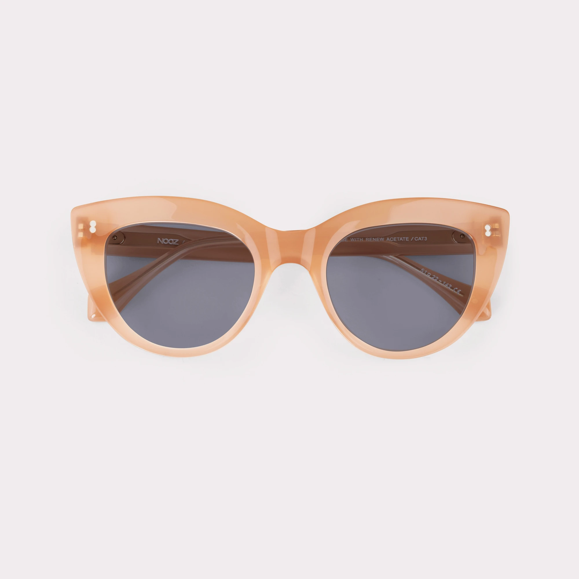 A pair of Romy Milky Pink Sunglasses folded