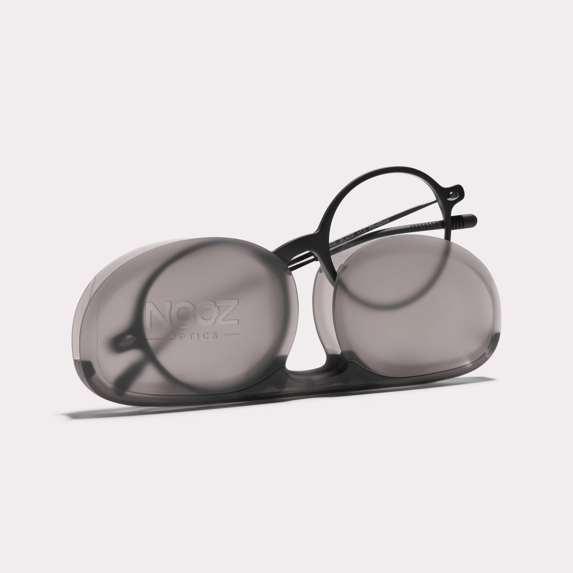 A pair of Milo Black Reading glasses coming out of its case
