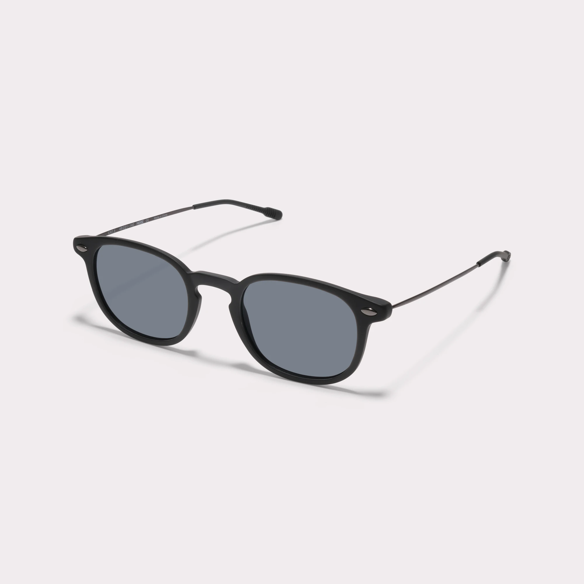 A pair of Alma Black Sunglasses  seen from the side