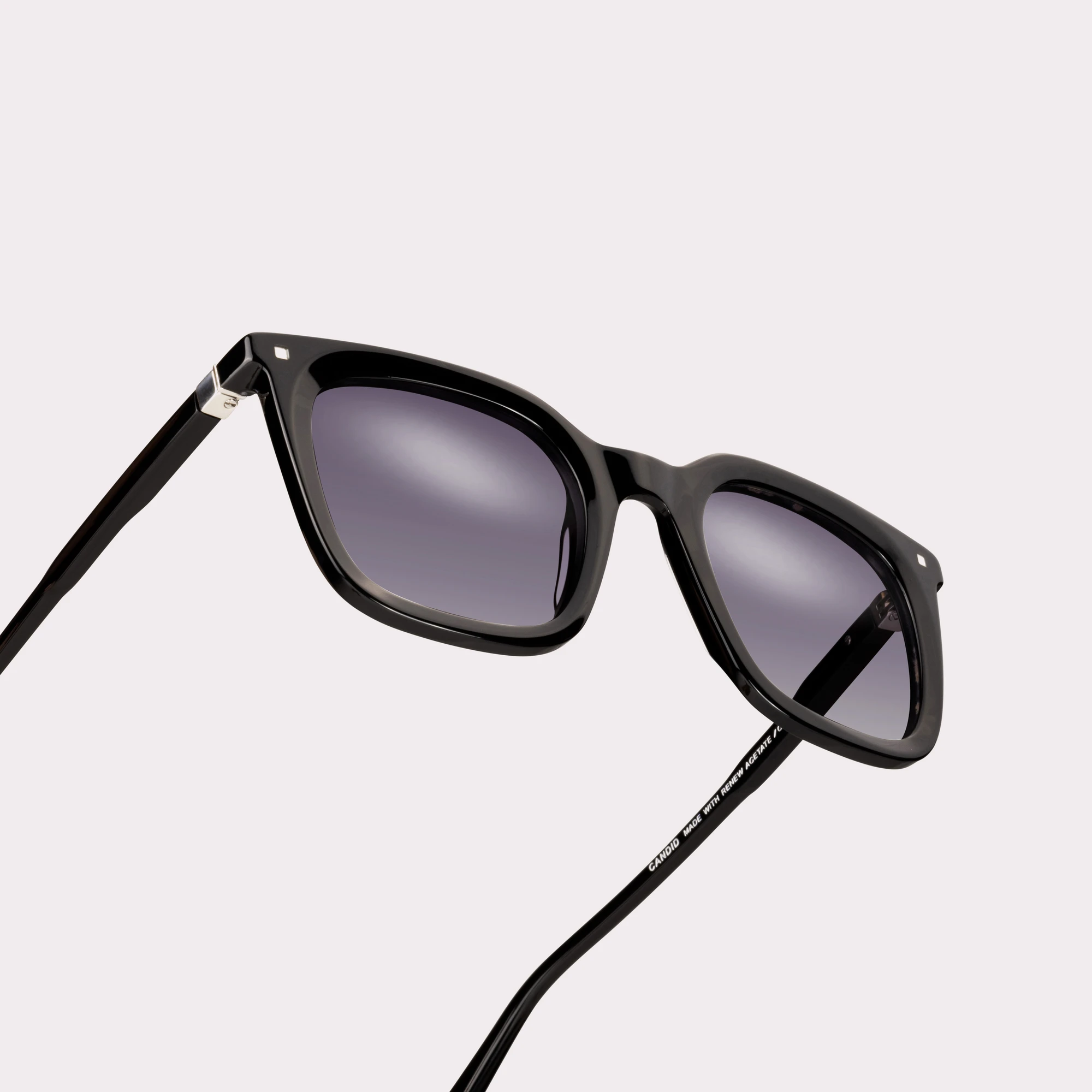A pair of Candid Black Sunglasses in a macro view